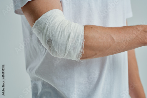 sick man in a white T-shirt with a bandaged hand hospital medicine