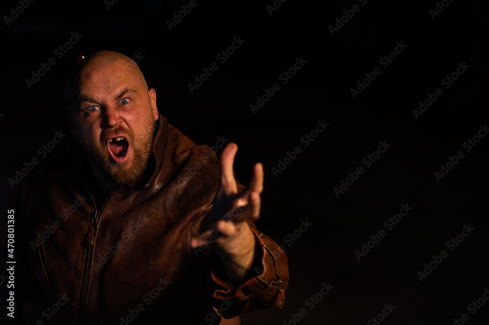 An angry man in a leather jacket attacks in the dark.