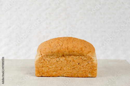 Wheat bread loaf on a white background.