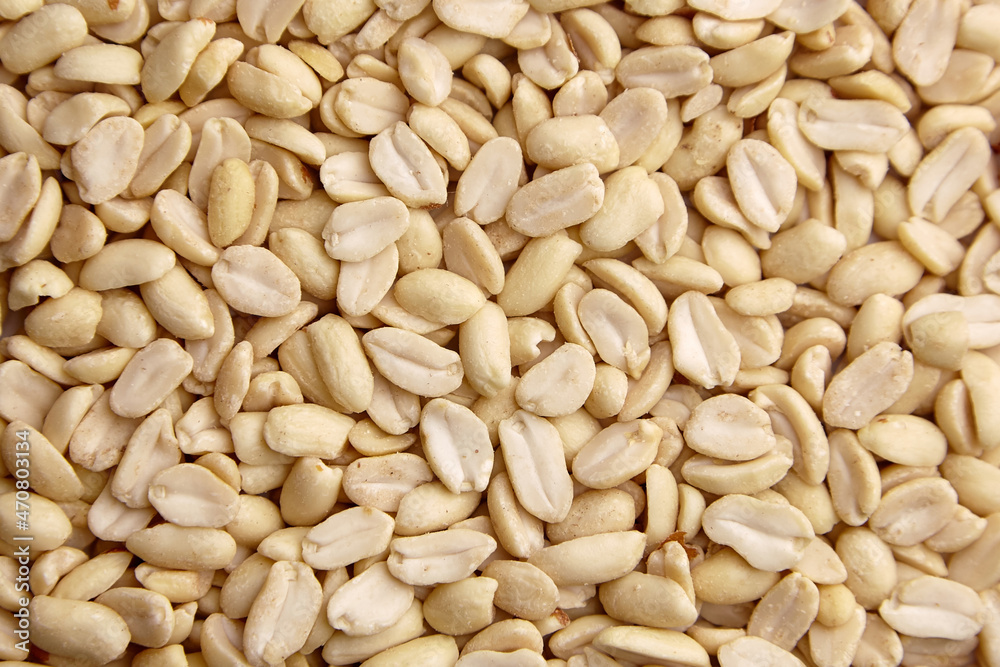 Raw blanched peanuts as food background