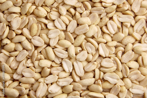 Raw blanched peanuts as food background photo