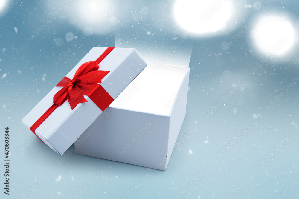 Opened white gift box with red ribbon Opened white gift box with red ribbon