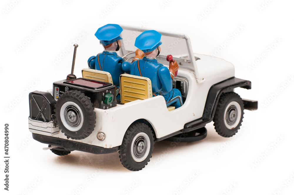 vintage tin police car toy on white background