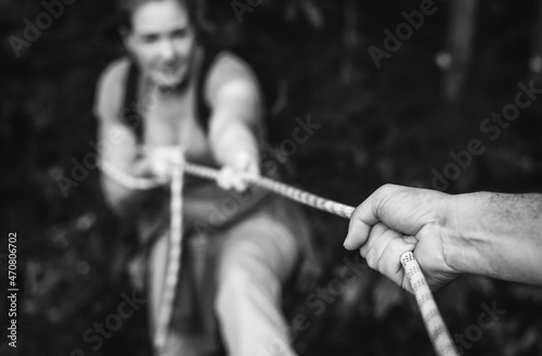 Woman climbing up a rope