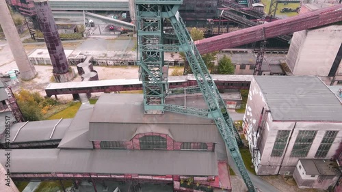 Drone footage of old industrial complex with mine, chimneys, blast furnace, factories and others