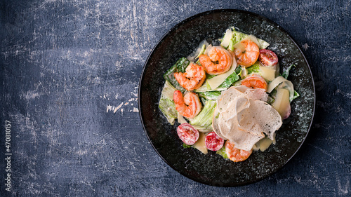 caesar salad with shrimp with copy space background