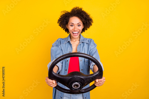 Fotografie, Tablou Photo of young cheerful happy afro american woman hold hands steering wheel isol