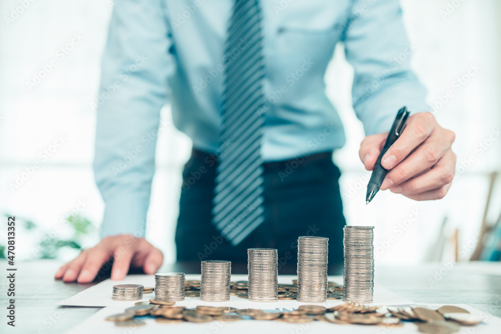 Hand putting money coins stack growing, saving money for finance accounting concept. Hand putting money coins stack growing, saving money for finance accounting concept.