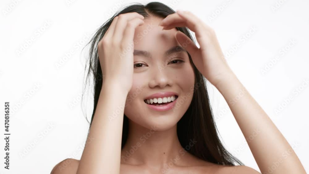 Japanese Woman Playing With Long Brunette Hair Over White Background Japanese Woman Playing With Long Brunette Hair Over White Background