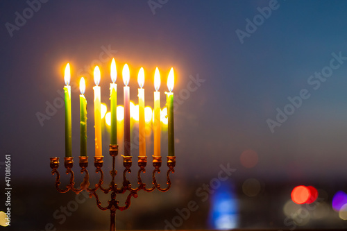Seventh day of Hanukkah. Light seven candles in the menorah. Hannukia on the windowsill. Traditions of the religion of Judaism. The main holiday of the Jews. Sunset night