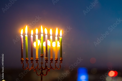 Eighth day of Hanukkah. Light eight candles in the menorah. Hannukia on the windowsill. Traditions of the religion of Judaism. The main holiday of the Jews. Sunset night