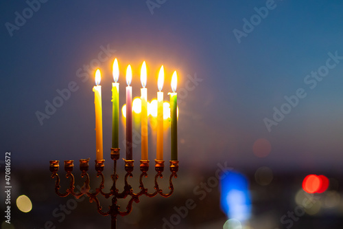 The fifth day of Hanukkah. Light five candles in the menorah. Hannukia on the windowsill. Traditions of the religion of Judaism. The main holiday of the Jews. Sunset night