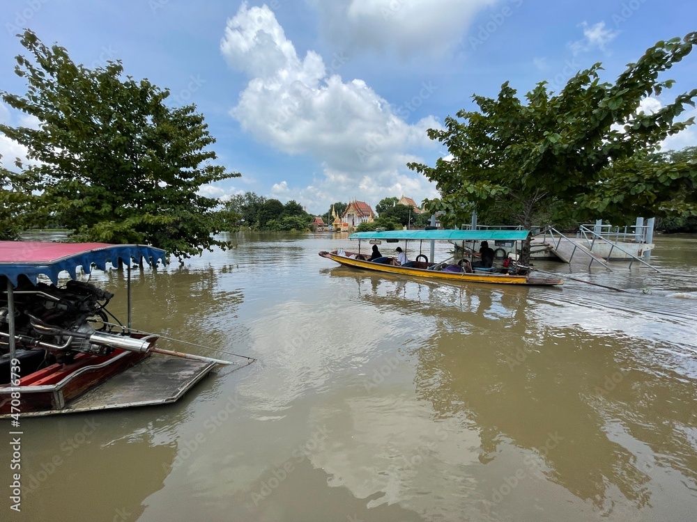 Naklejka premium A river with boats passing through different places.