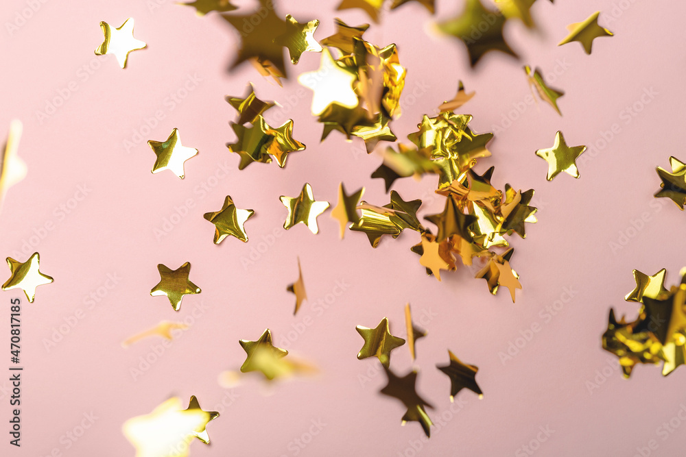 Background with flying gold confetti stars. Pink background. Wallpaper. Background with flying gold confetti stars. Pink background. Wallpaper.