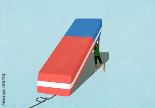 Woman lifting large eraser
