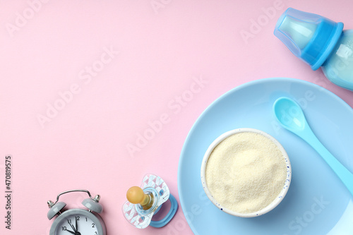 Concept of baby food with   owdered milk on pink background