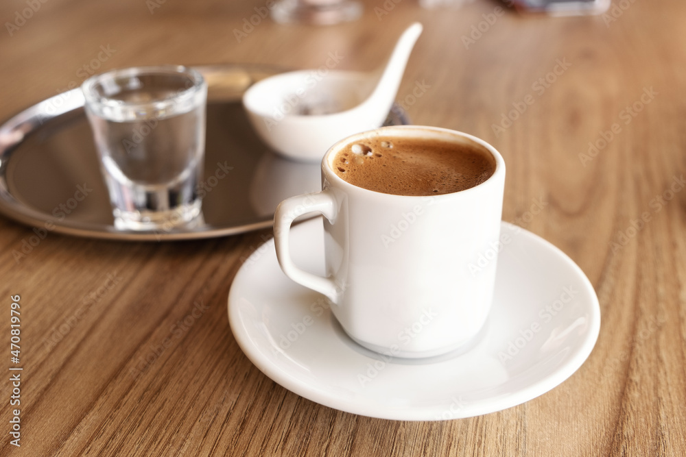 Traditional Turkish coffee with cold water and Turkish delight in cafe. Selective focus Traditional Turkish coffee with cold water and Turkish delight in cafe. Selective focus