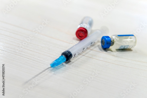 syringe and two vials of vaccine on a white background. Drugs for erectile dysfunction ED disease