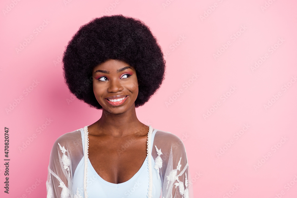 Photo portrait curly woman smiling wearing white clothes looking blank space isolated pastel pink color background