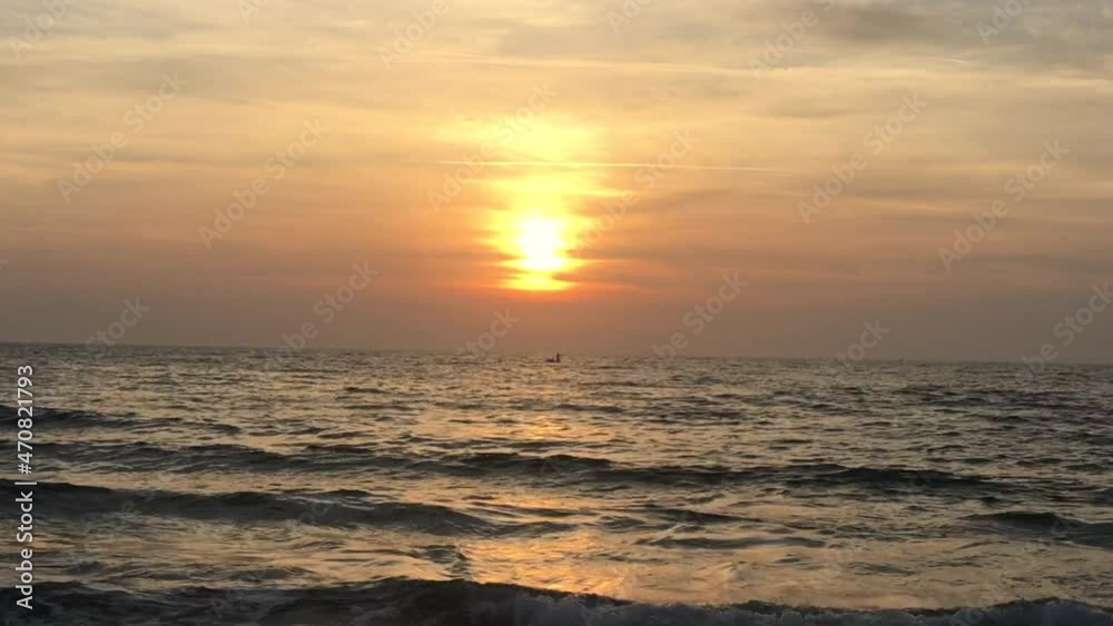 Zoom Out Sea waves reaching the beach at sunset Zoom Out Sea waves reaching the beach at sunset