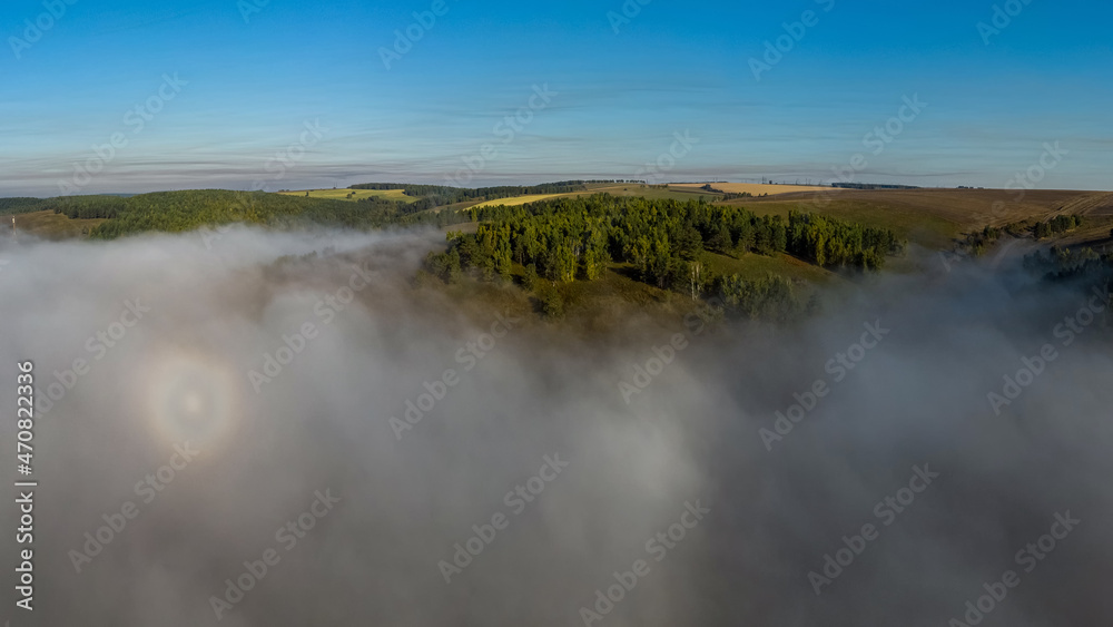 Aerial view of fog soaring over the forests