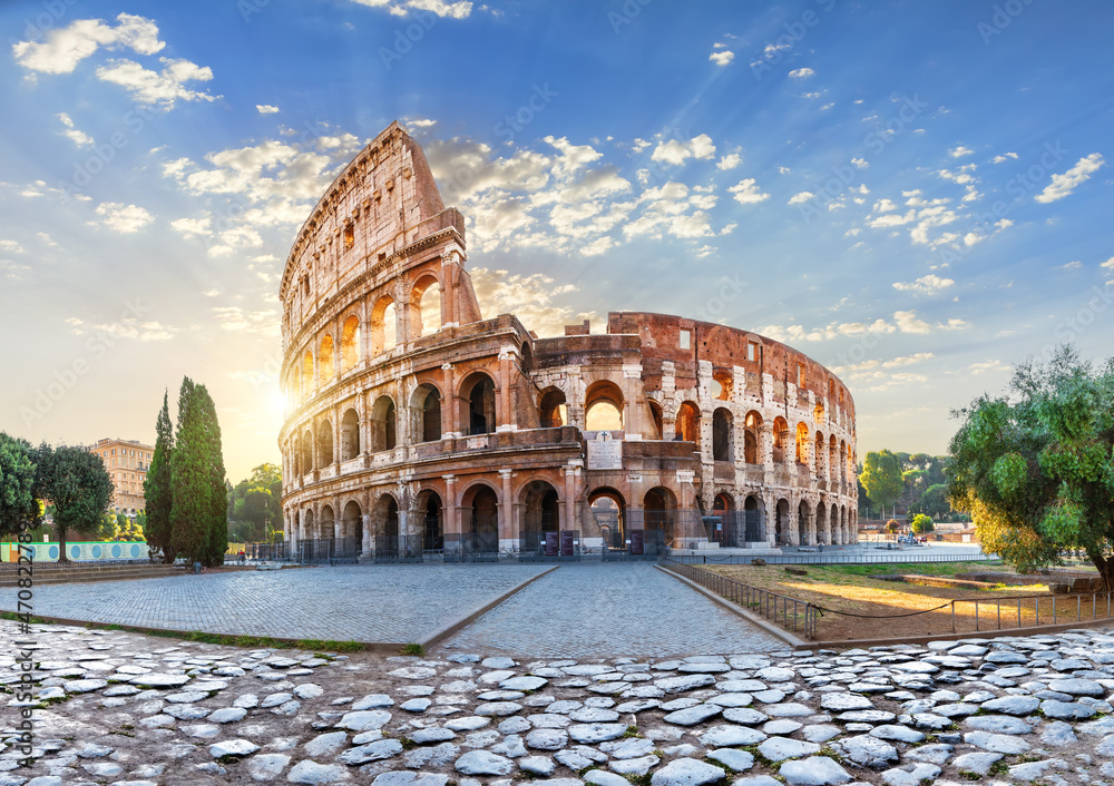 The Colosseum in the morning sun rays, beautiful morning view of Rome, Italy
