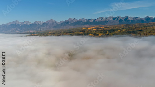 A view from a height of the Sayan mountains and clouds below