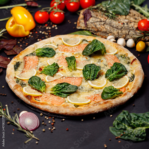 Top view pizza on table top, Flat lay of pizza on black background, Prepared pizza on table for serve Freshly baked homemade pizza isolated on a black background with vegetables. View from above