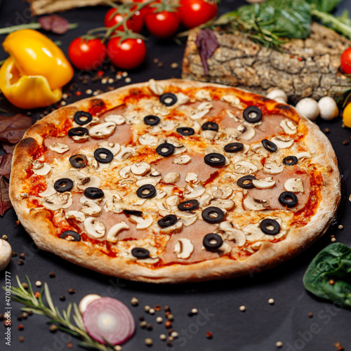 Top view pizza on table top, Flat lay of pizza on black background, Prepared pizza on table for serve Freshly baked homemade pizza isolated on a black background with vegetables. View from above