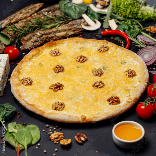 Top view pizza on table top, Flat lay of pizza on black background, Prepared pizza on table for serve Freshly baked homemade pizza isolated on a black background with vegetables. View from above