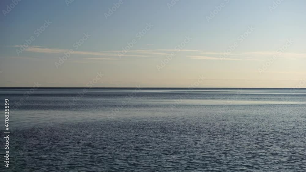 Abstract nature summer ocean sunset sea background. Small waves on water surface in motion blur with bokeh lights from sunrise. Holiday, vacation and recreational background concept. Slow motion Abstract nature summer ocean sunset sea background. Small waves on water surface in motion blur with bokeh lights from sunrise. Holiday, vacation and recreational background concept. Slow motion