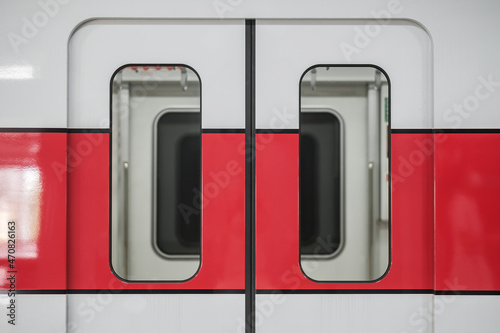 Red line train at public transportation station photo