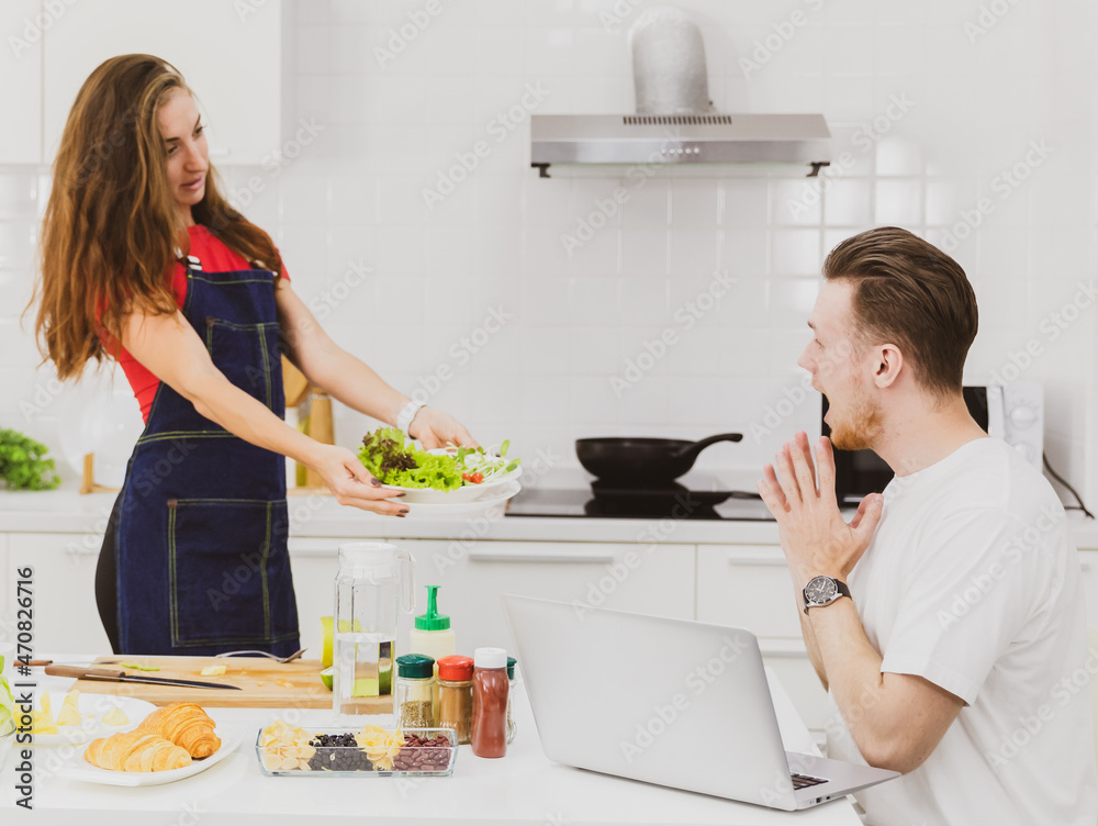 Girlfriend showing salad to boyfriend