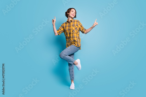 Photo of carefree cute lady dance enjoy discotheque wear checkered shirt jeans shoes isolated blue color background