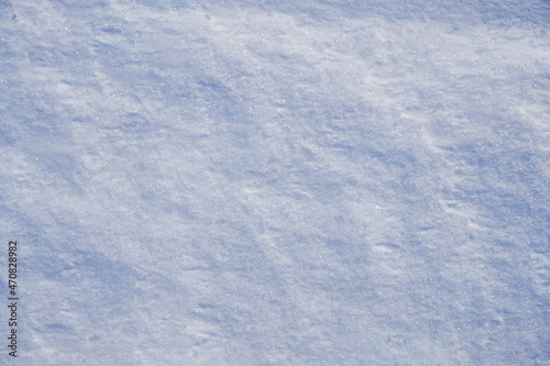Texture of winter snow surface. Blue natural snow background. © Serg Zastavkin