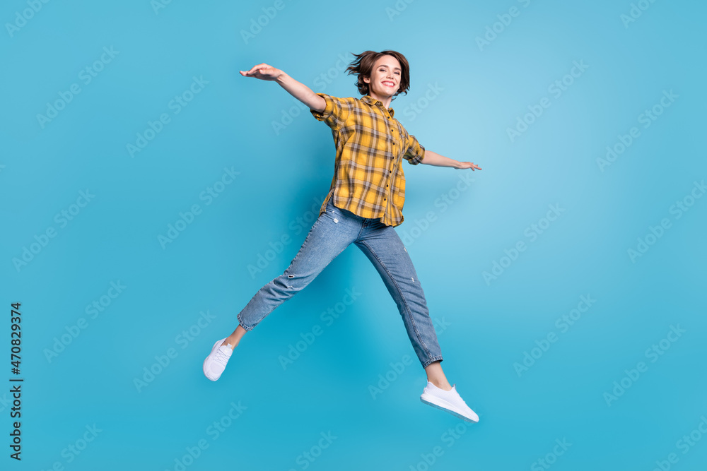 Photo of lovely inspired lady jump fly posing plane wear plaid shirt jeans footwear isolated blue color background