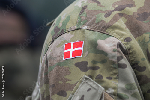 Danish army uniform with the Danish flag on the shoulder. Danish military, selective focus.