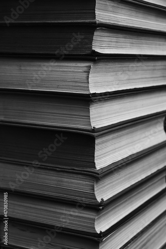 Large stack of books in a black and white photograph.