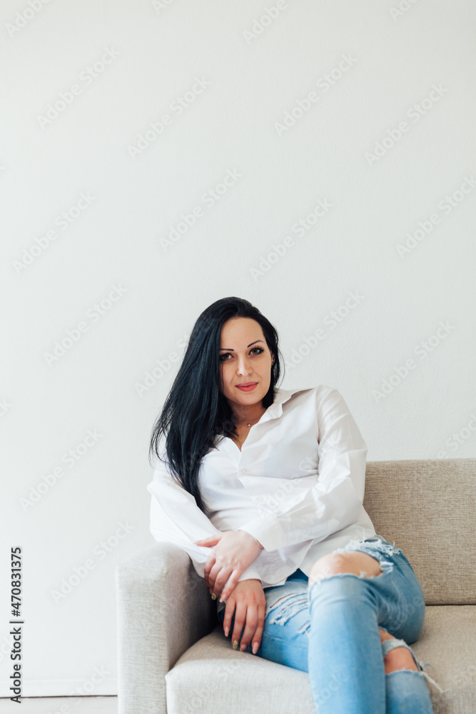 beautiful woman brunette on the office sofa at home beautiful woman brunette on the office sofa at home