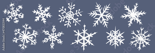 Set of white snowflakes on a dark gray background. Collection of various hand-drawn doodle style snowflakes. Symbol of winter snow. Elements for Christmas winter design. Vector.