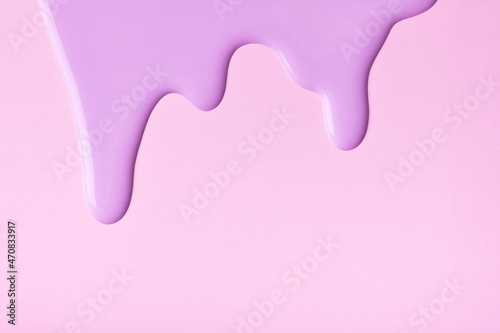 Light lilac liquid drops of paint color flow down on pink background Fototapeta
