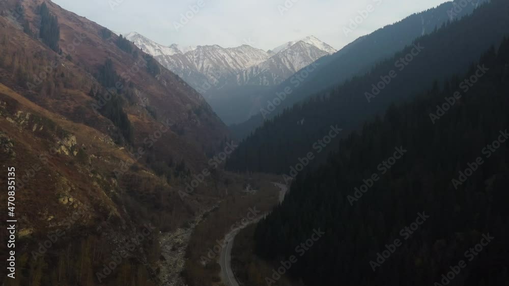 Cinematic drone shot flying through a valley towards the Trans-Ili Alatau mountains in Kazakhstan Cinematic drone shot flying through a valley towards the Trans-Ili Alatau mountains in Kazakhstan