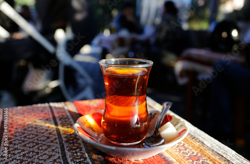 A cup of hot Turkish tea is served in a restaurant at Kadikoy district, city of Istanbul, Turkey.