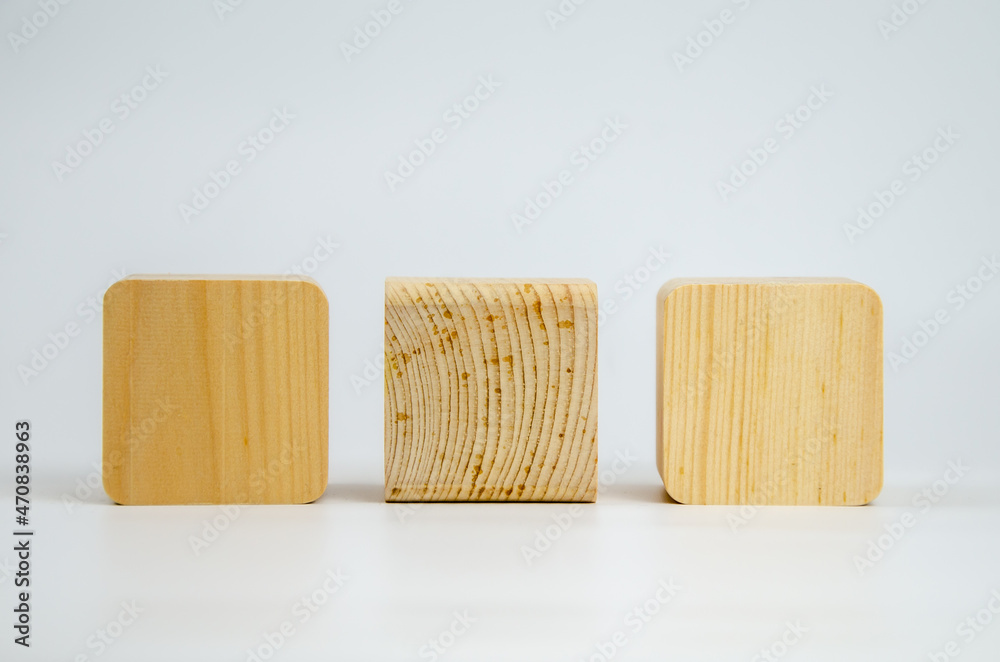 Wooden cubes from different tree species with different edge treatments. several wooden building blocks on a white background. Eco-friendly materials for construction, decoration and repair. Wooden cubes from different tree species with different edge treatments. several wooden building blocks on a white background. Eco-friendly materials for construction, decoration and repair.