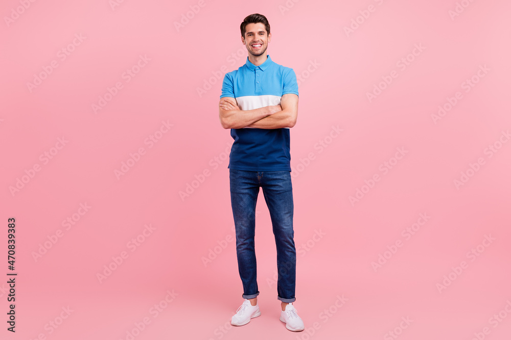 Full size photo of cool brunet young guy stand wear polo jeans sneakers isolated on pink background Full size photo of cool brunet young guy stand wear polo jeans sneakers isolated on pink background