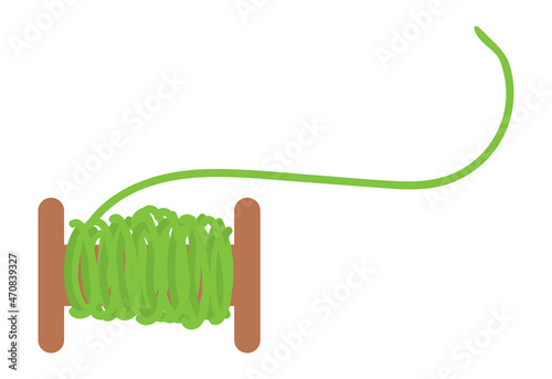 Sewing thread on wooden bobbin. Green cotton. Tailor tool