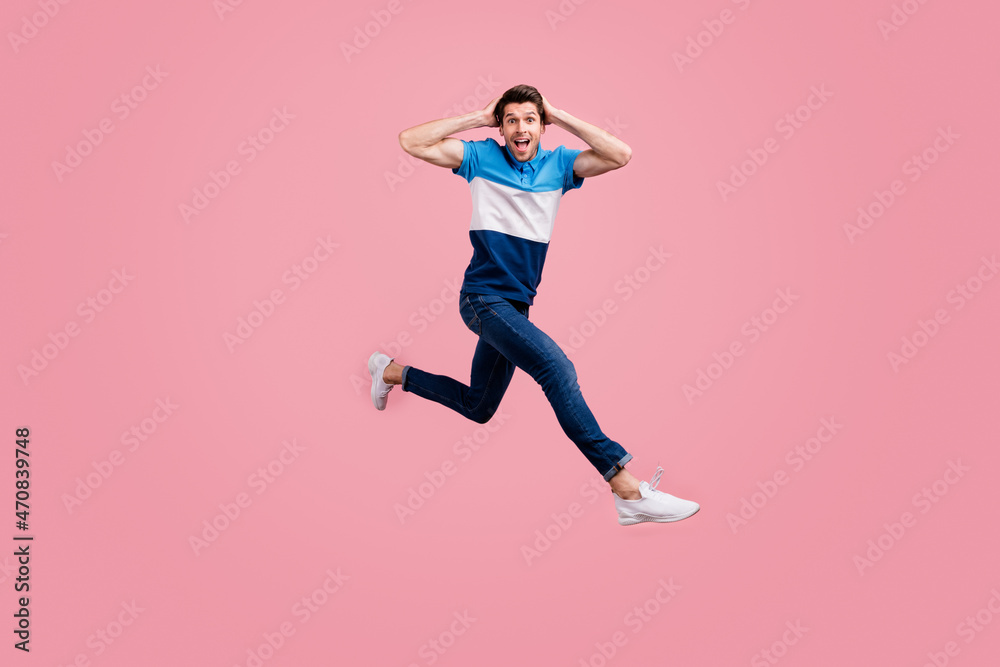 Full size photo of impressed brunet young guy run wear polo jeans sneakers isolated on pink background