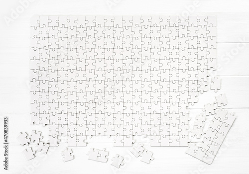 Quadro su tela Matching pieces of empty puzzle on white background