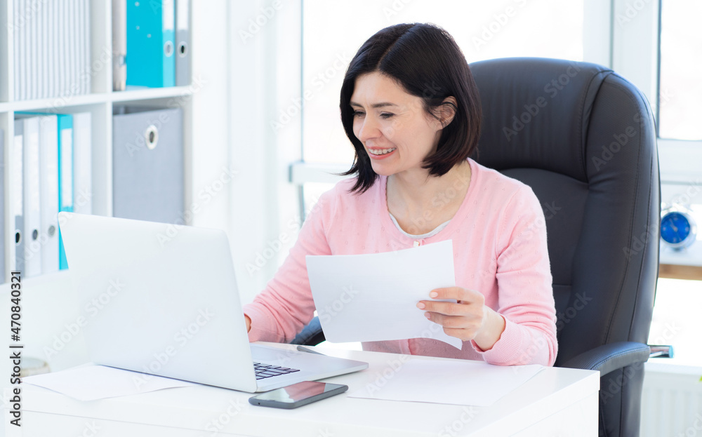 Stylish woman working on laptop in light office Stylish woman working on laptop in light office