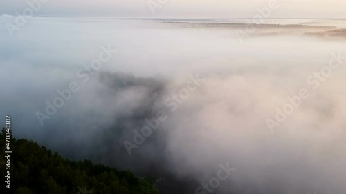 Flight over clouds, wood in sunrise time. Aerial landscape